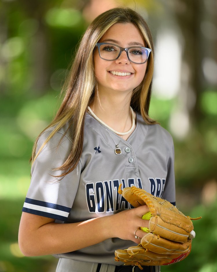 Softball player in a Gonzaga Prep jersey posing with her glove outdoors
